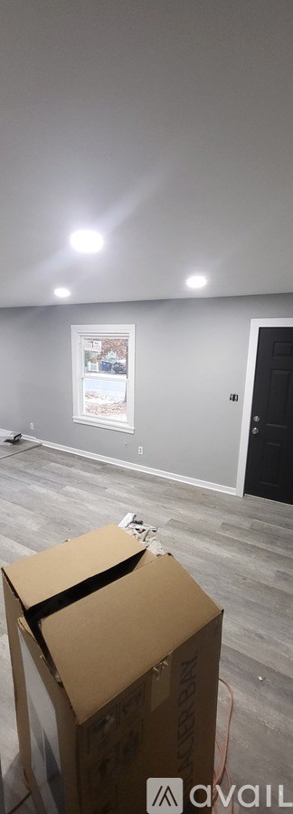 A room with a box on the floor.