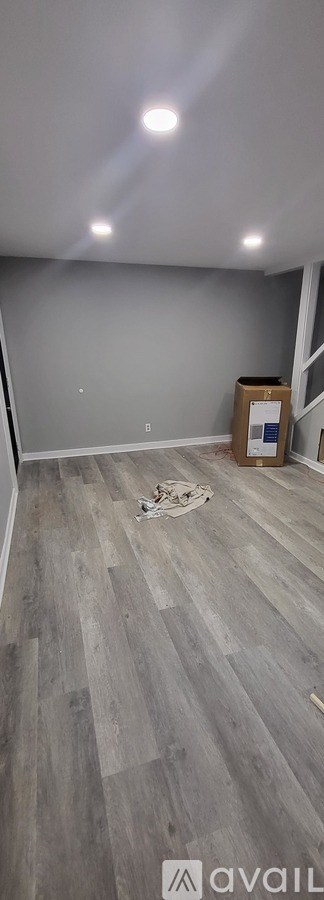 A room with grey walls and a wooden floor.