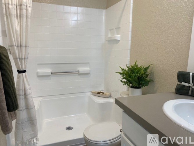 A bathroom with a toilet, sink, and bathtub.