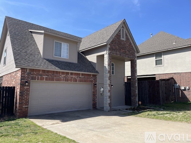 A house with a garage and a driveway in front.