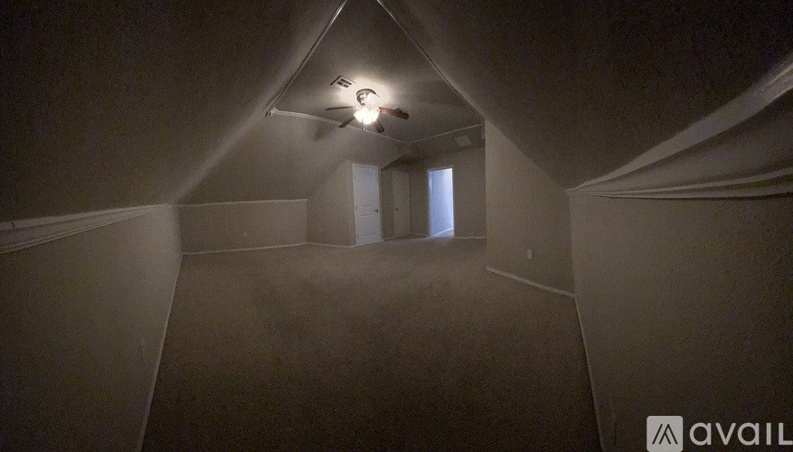 A room with a light on the ceiling and a window on the wall.