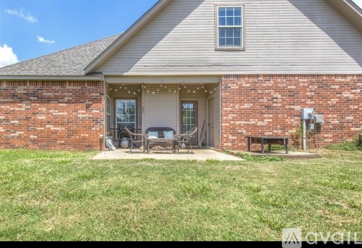 A house with a brick wall and a covered patio.