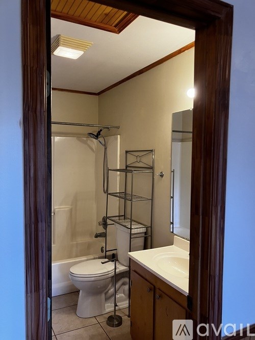 A bathroom with a toilet, sink, and shower.