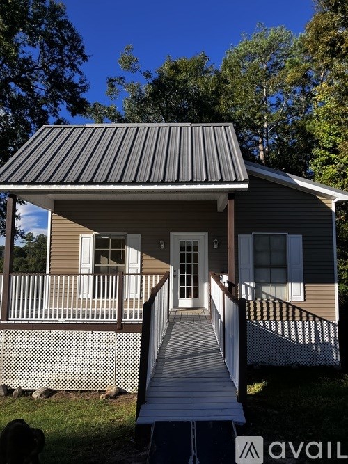 A house with a porch and a dog.