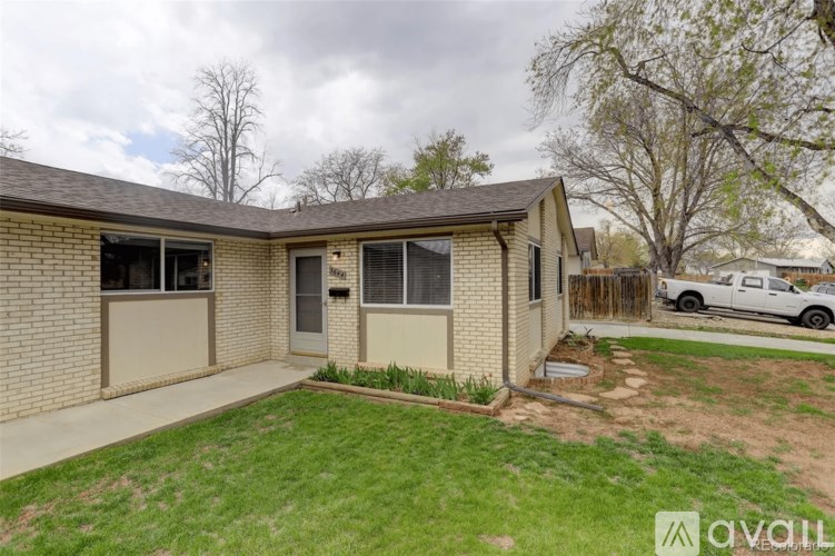 A house with a brown roof and beige siding is for sale.