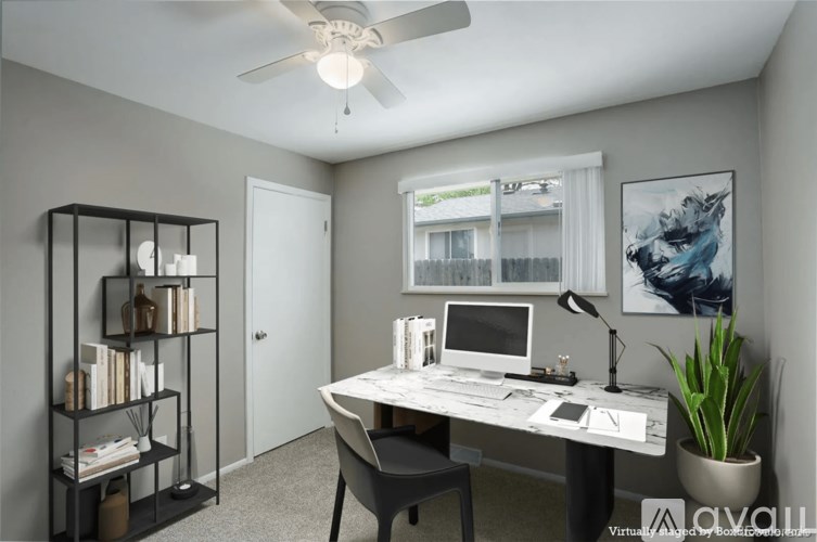 A room with a desk, chair, and bookshelf.