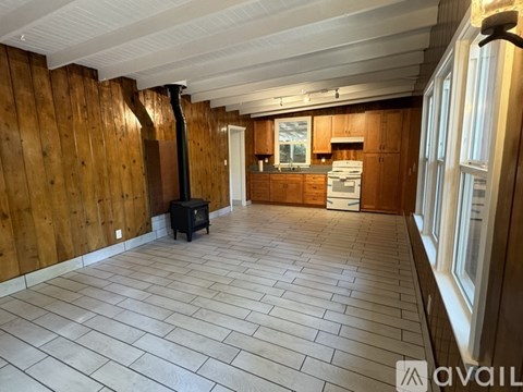 A room with wooden walls and a tiled floor.