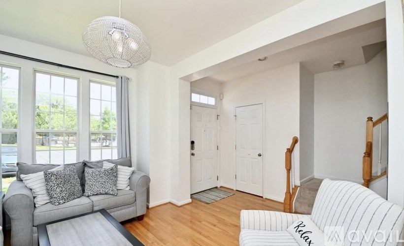 A living room with a grey couch and a white couch.