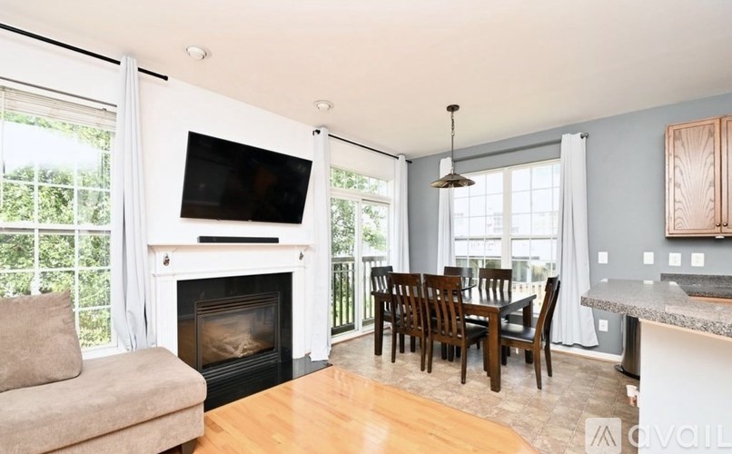 A living room with a fireplace and a television.