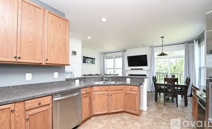 A kitchen with wooden cabinets and a black countertop.