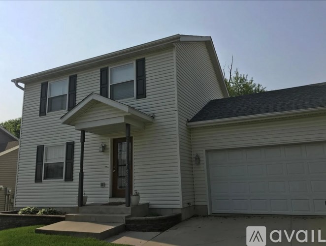 A two-story house with a garage and a front porch.