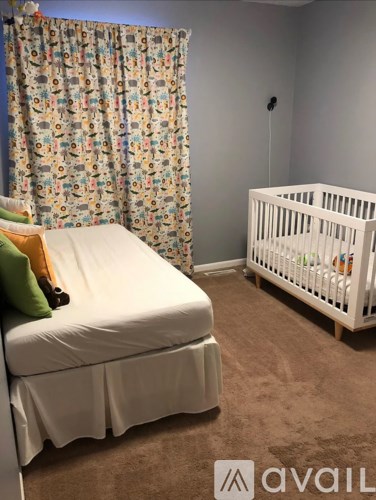 A baby room with a crib and a changing table.