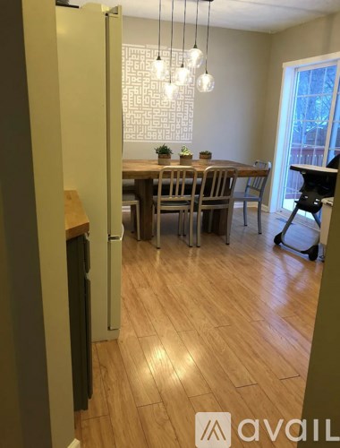A kitchen with a dining table and chairs.