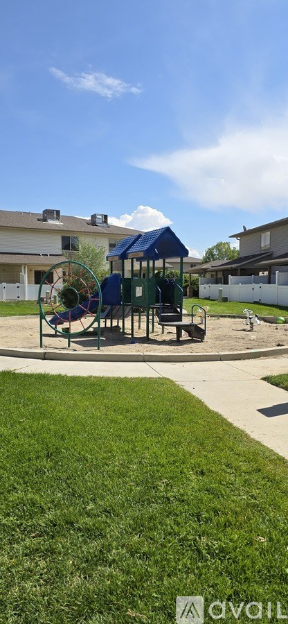 A playground with a blue roof and a slide.