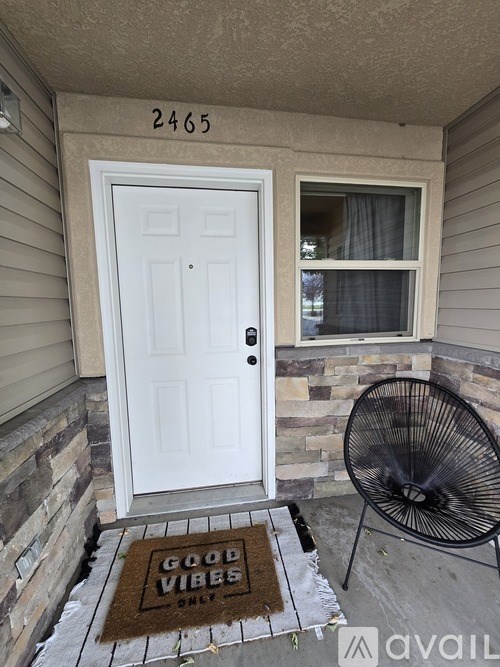 A white door with a glass window above it and a fan on the right.