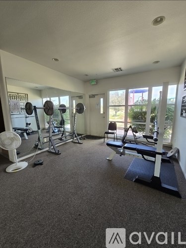 A bedroom with a bed, chair, and window.