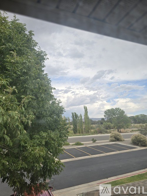 A parking lot with a cloudy sky in the background.