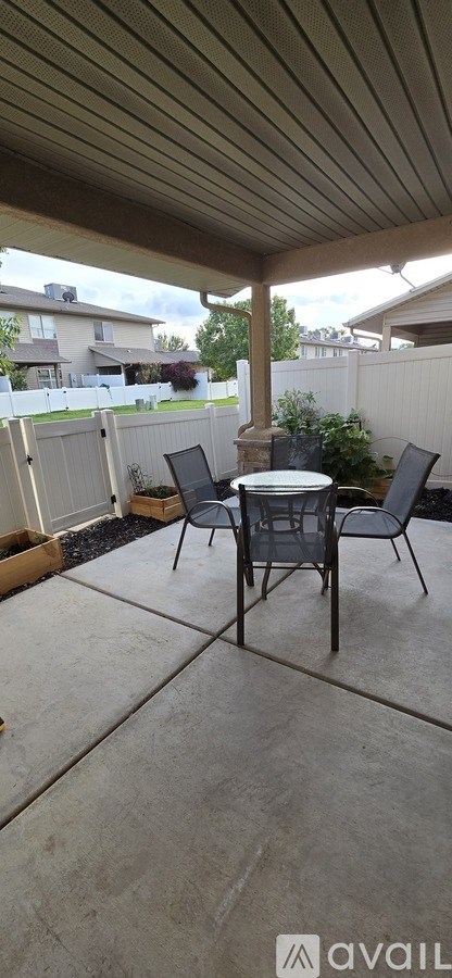 A patio with a table and chairs.