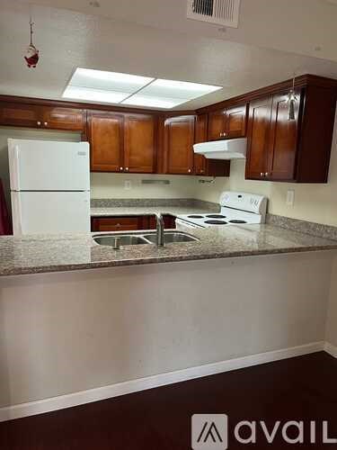 A kitchen with a white fridge and a white stove.