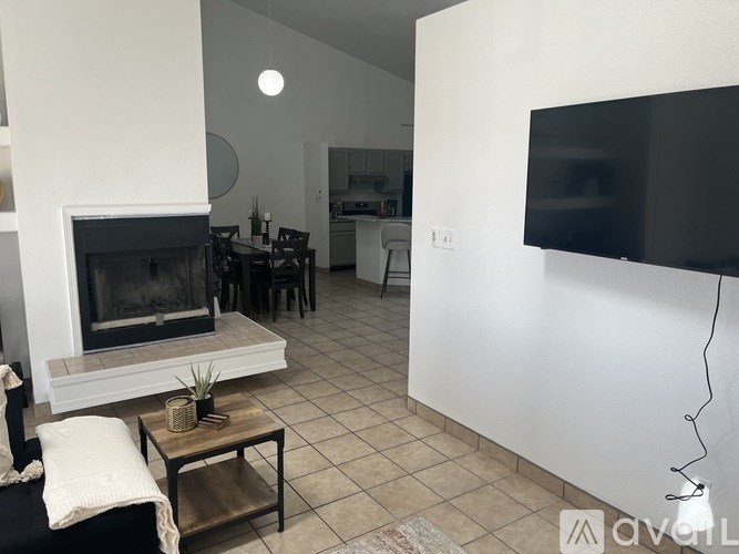 A living room with a fireplace and a television.