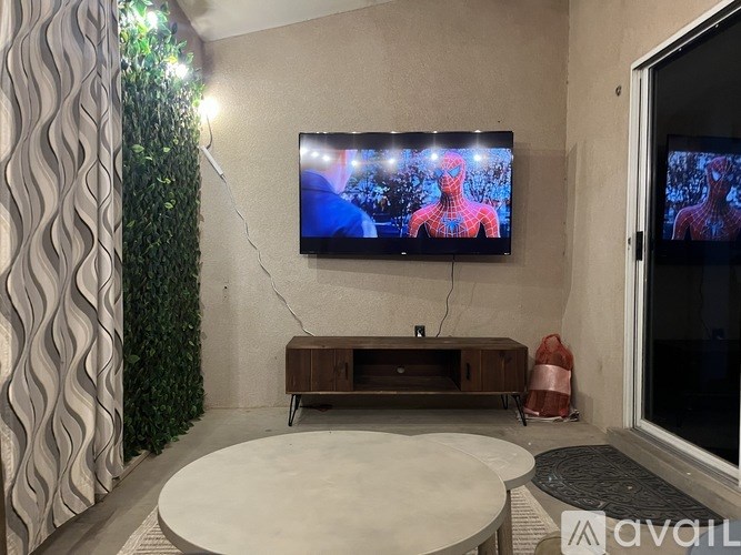 A room with a television displaying Spider-Man on the screen.