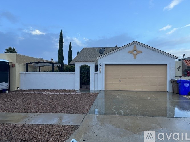 A house with a garage and a driveway in front of it.