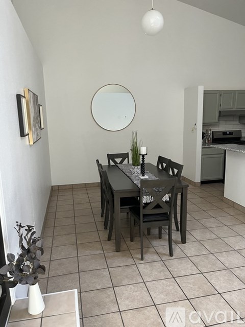 A dining room with a table set for two.
