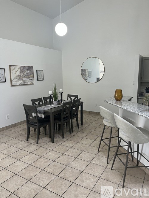 A dining room with a table set for six.