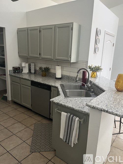 A kitchen with a sink and a dishwasher.