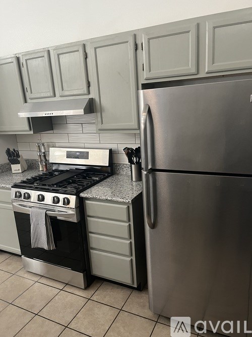 A modern kitchen with a stove and refrigerator.
