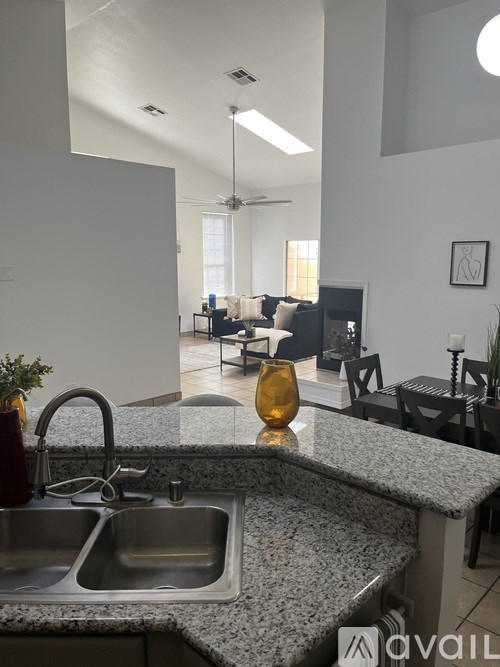 A kitchen with granite countertops and a sink.