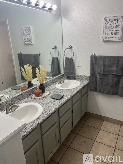 A bathroom with two sinks and a mirror.