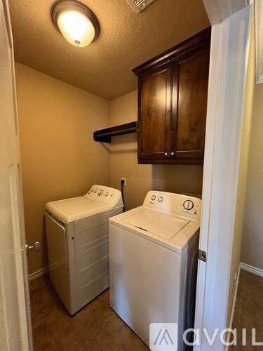 A small laundry room with a washer and dryer.
