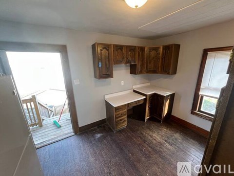 A kitchen with a table and chairs in front of a window.
