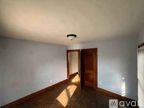 A room with a wooden floor and a ceiling light.