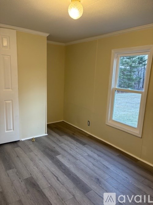 A room with a window and a door.