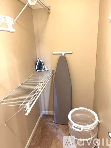 A bathroom with a towel rack and a toilet brush.