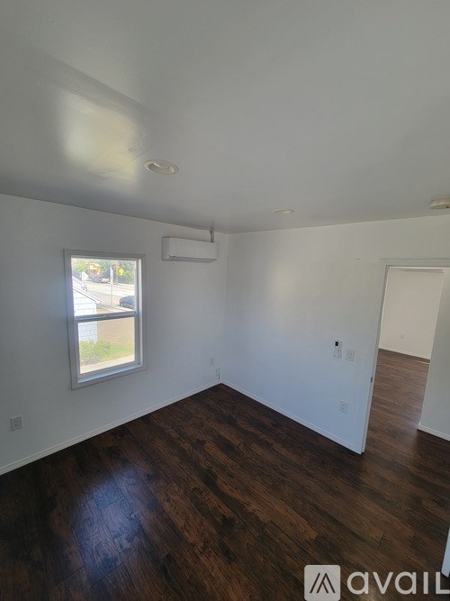 A room with wooden floors and a window.