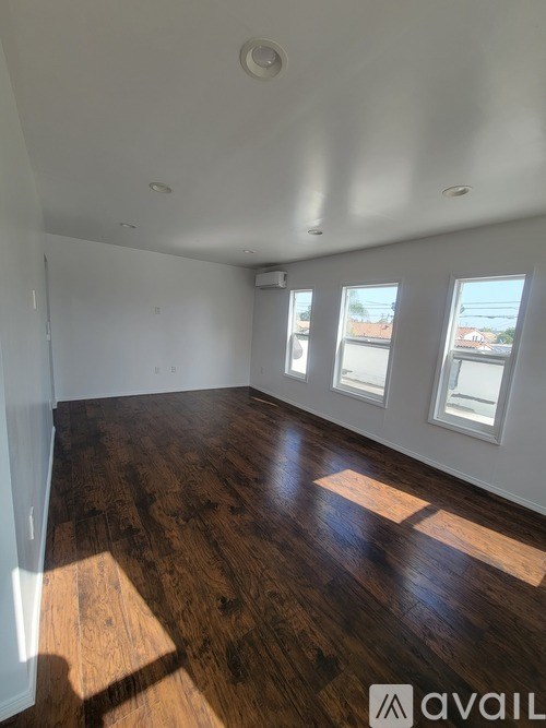 A room with wooden floors and white walls.