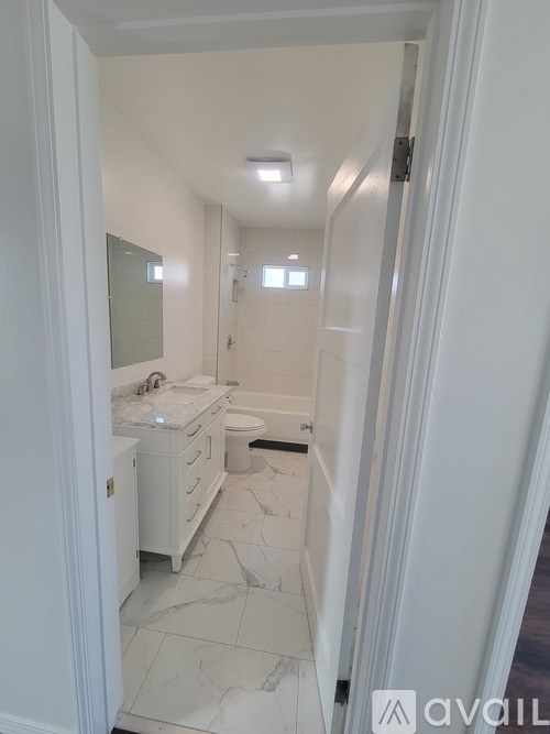 A bathroom with a sink, toilet and bathtub.