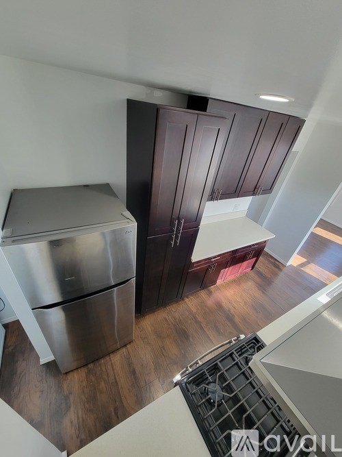 A modern kitchen with a stainless steel dishwasher and wooden cabinets.