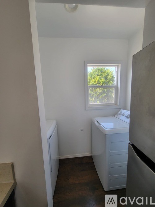 A small bathroom with a window and a sink.
