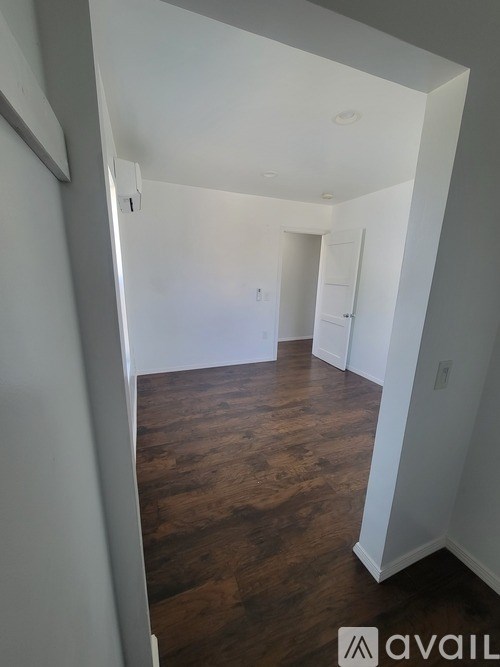 A room with wooden floors and white walls.