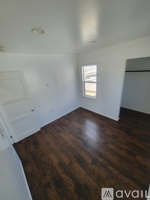 A room with wooden floors and a window.