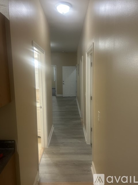 A long hallway with doors on both sides.