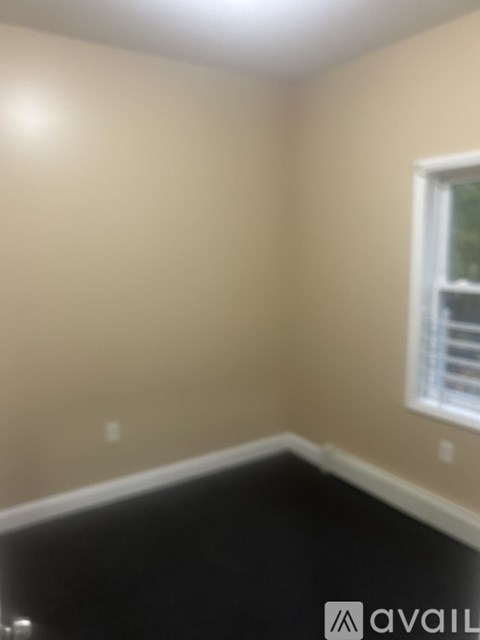 A room with a window and a white ceiling.