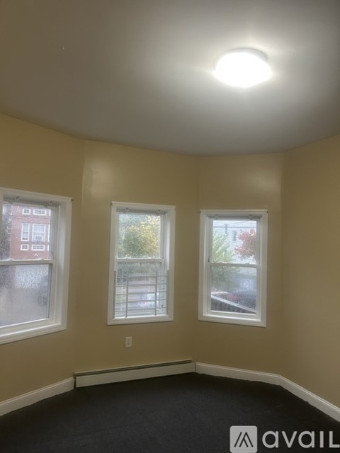 A room with two windows and a ceiling light.