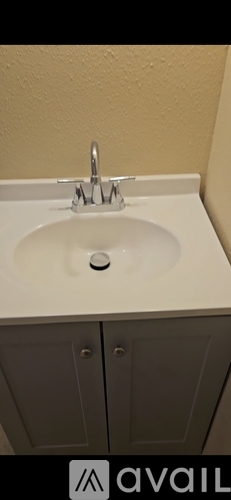 A kitchen sink with a chrome faucet.