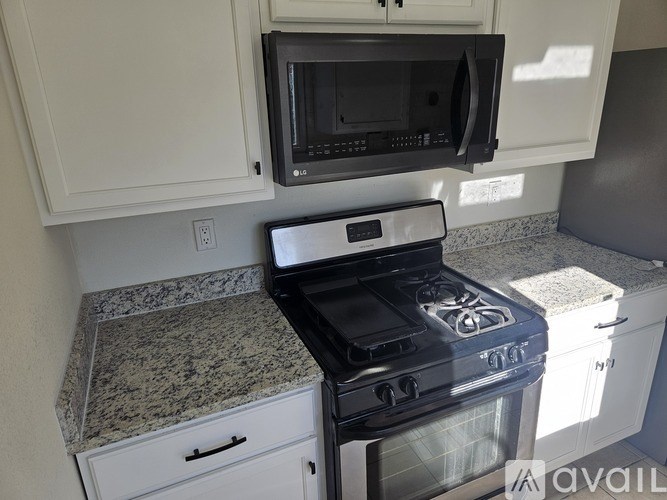 A black stove top oven with a microwave above it.