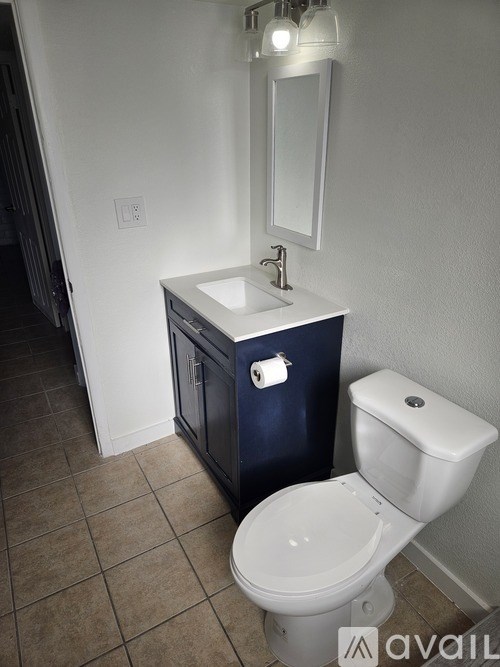 A white toilet sits next to a sink in a bathroom.